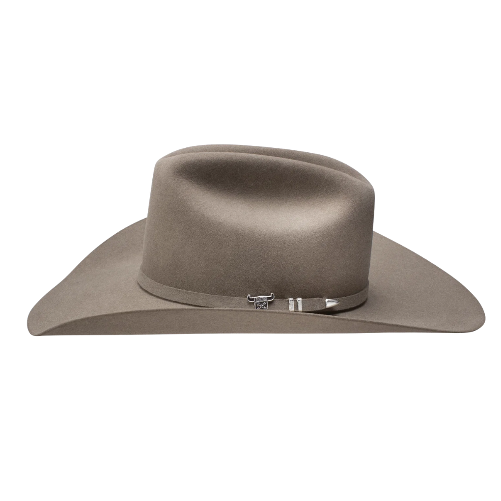 A classic cowboy hat in a taupe brown color, featuring a wide brim, a pinched crown, and a matching brown band with a silver buckle closure, set against a plain white background.